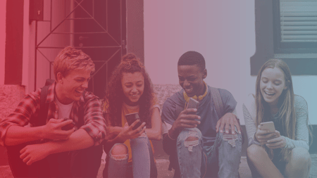 mogli text messaging + salesforce pardot communications bundle for k12 schools, older students laughing and texting