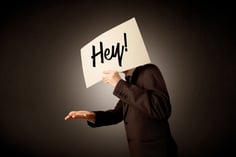 Young businessman hiding behind a greeting drawn on paper-2