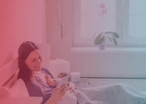 happy new mother texting from the comfort of her bed